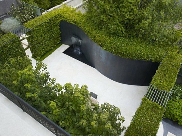 modern landscape design small patio curved wall hedge plants